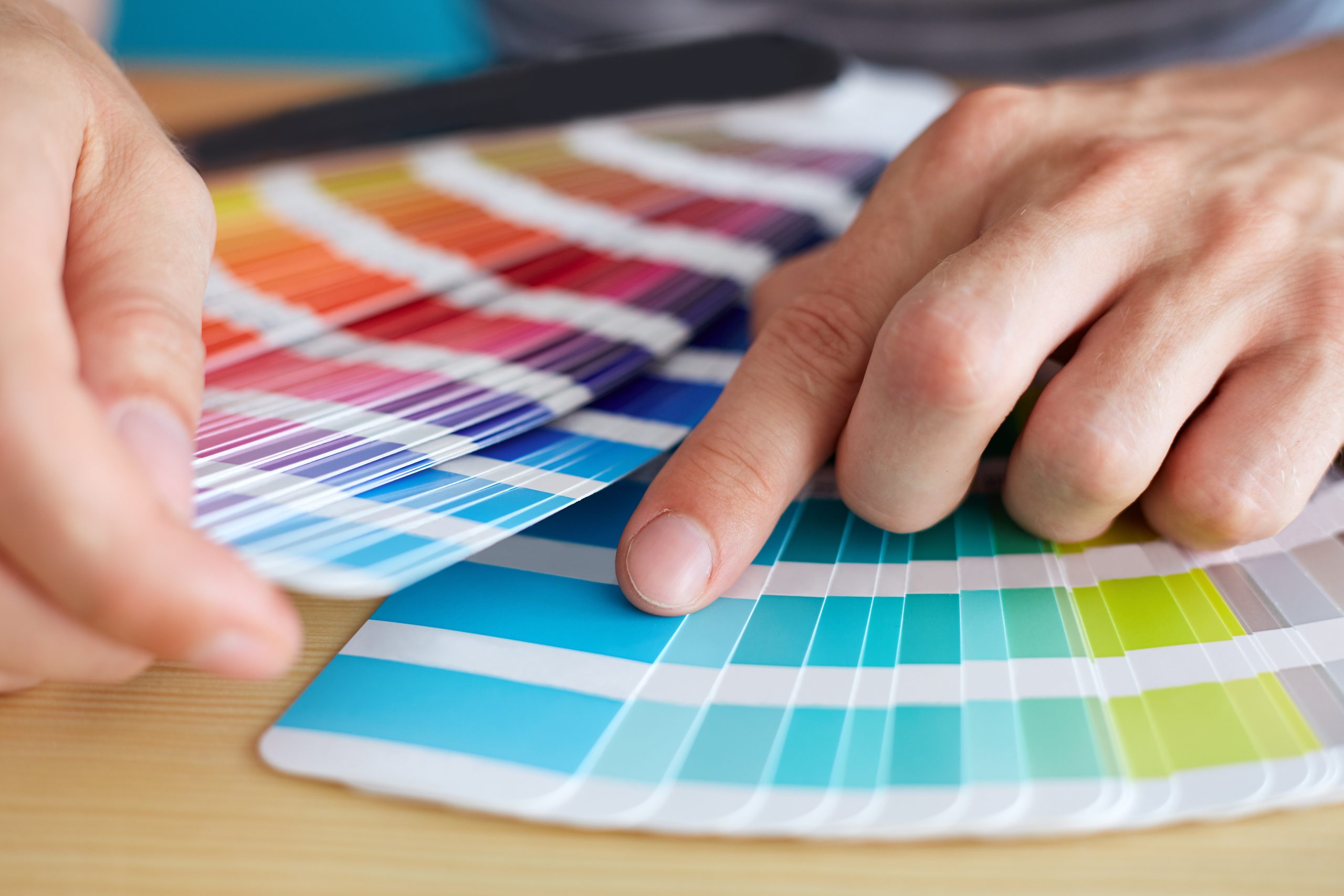Graphic,Designer,Choosing,A,Color,From,The,Sampler Graphic,Designer,Choosing,A,Color,From,The,Sampler